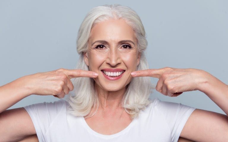 Elderly Woman Pointing At New Implants